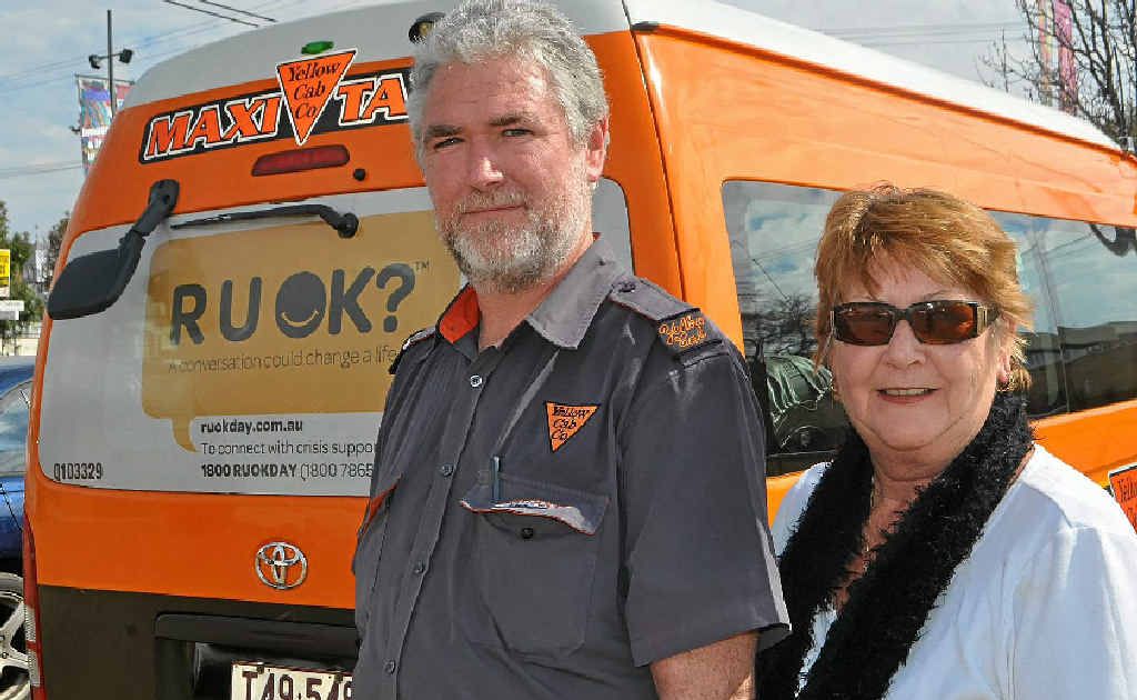 Owner of Warwick Yellow Cabs Nancy Miller, pictured with driver Gary Lang, put R U OK? stickers on two of her cabs which service Warwick.